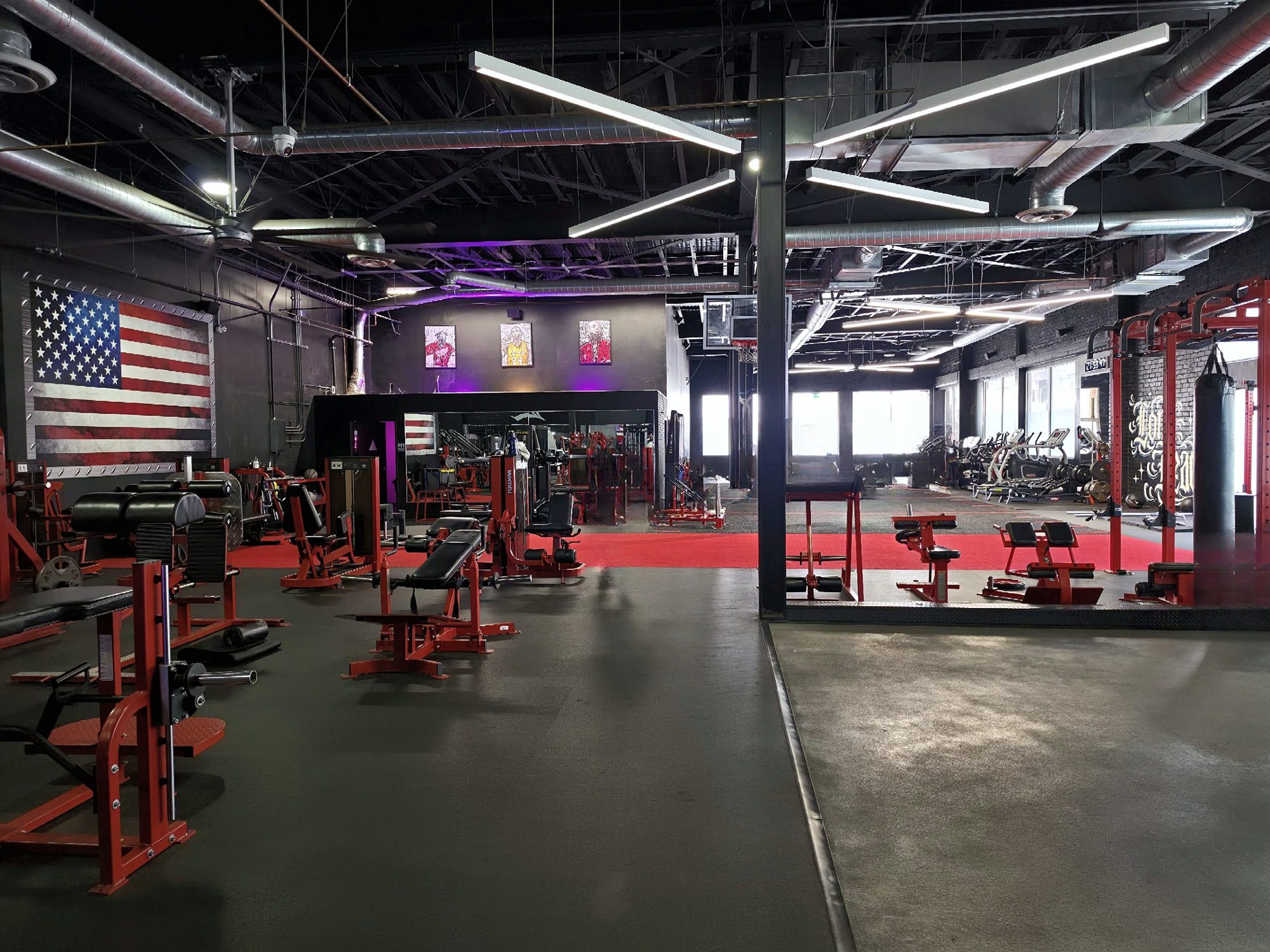 The main floor: benches and strength equipment under a large American flag